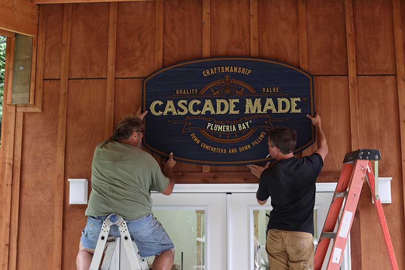 Installing the Cascade Made™ sign over the entryway