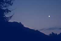 image of the moon rising over the ridge