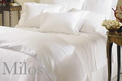 image of a bed made with Sferra Milos Sateen bed linens